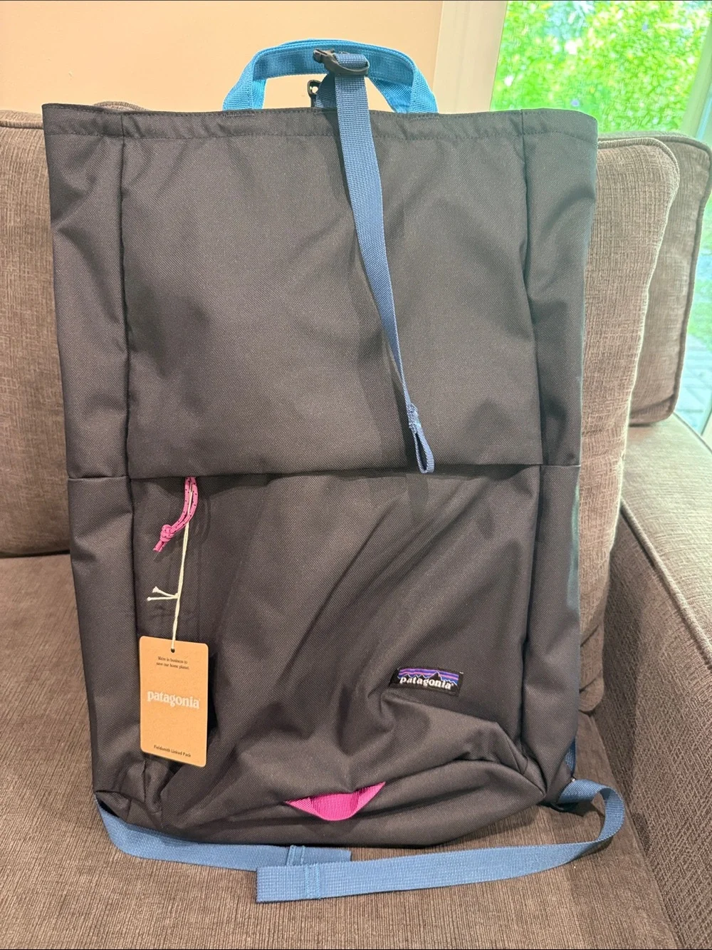 Patagonia Fieldsmith Black Roll-Top Backpack with Blue Handles and Pink Accents